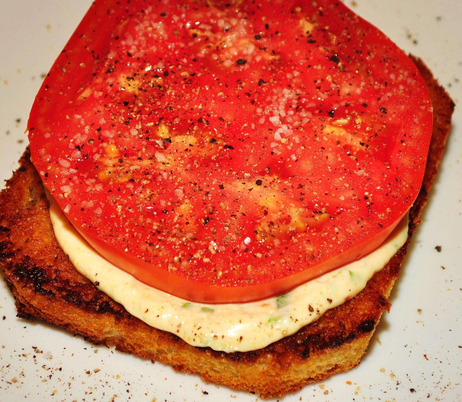Fresh tomato sandwich with basil on rustic bread