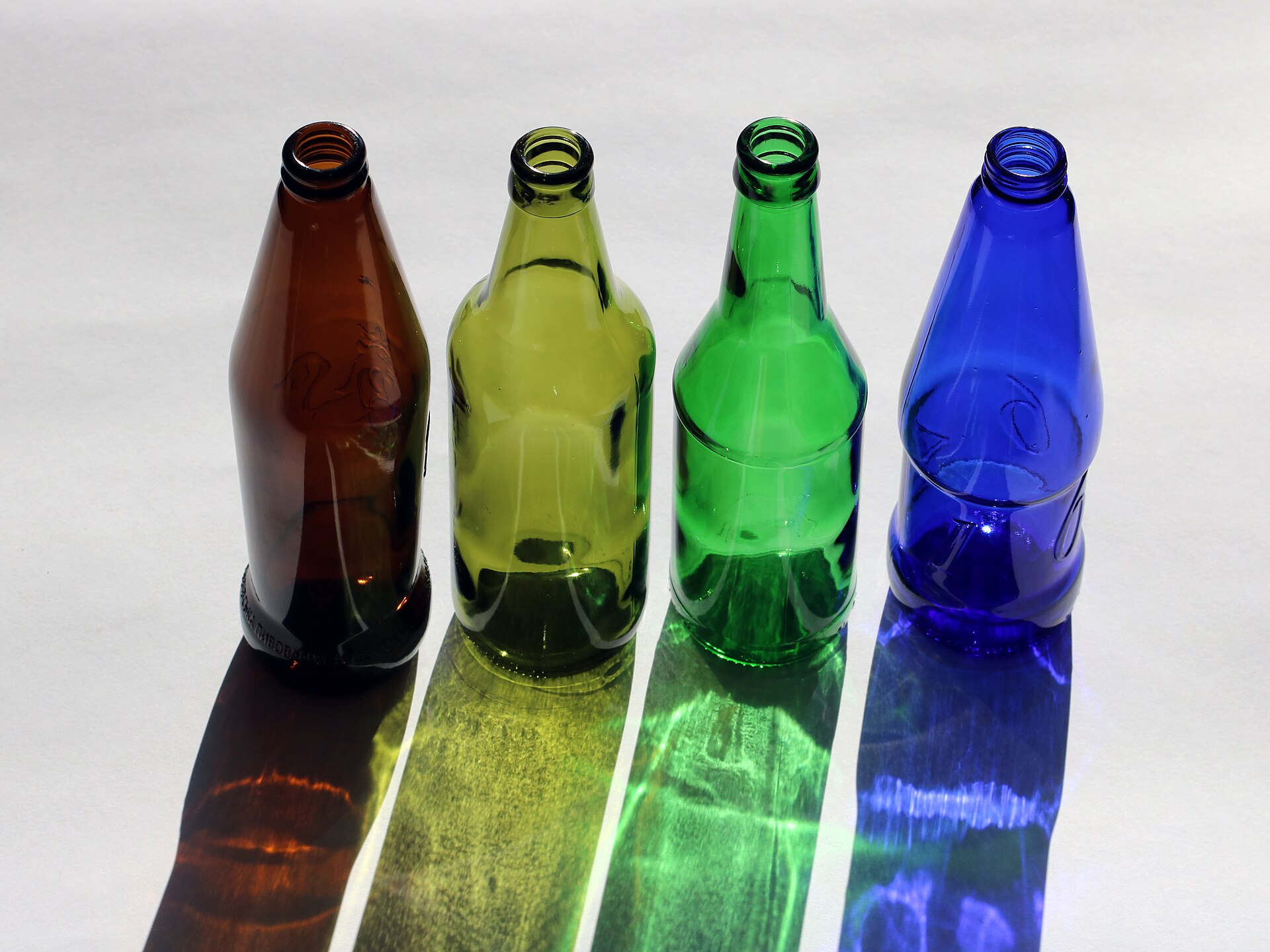 Beer bottles lined up in bright light