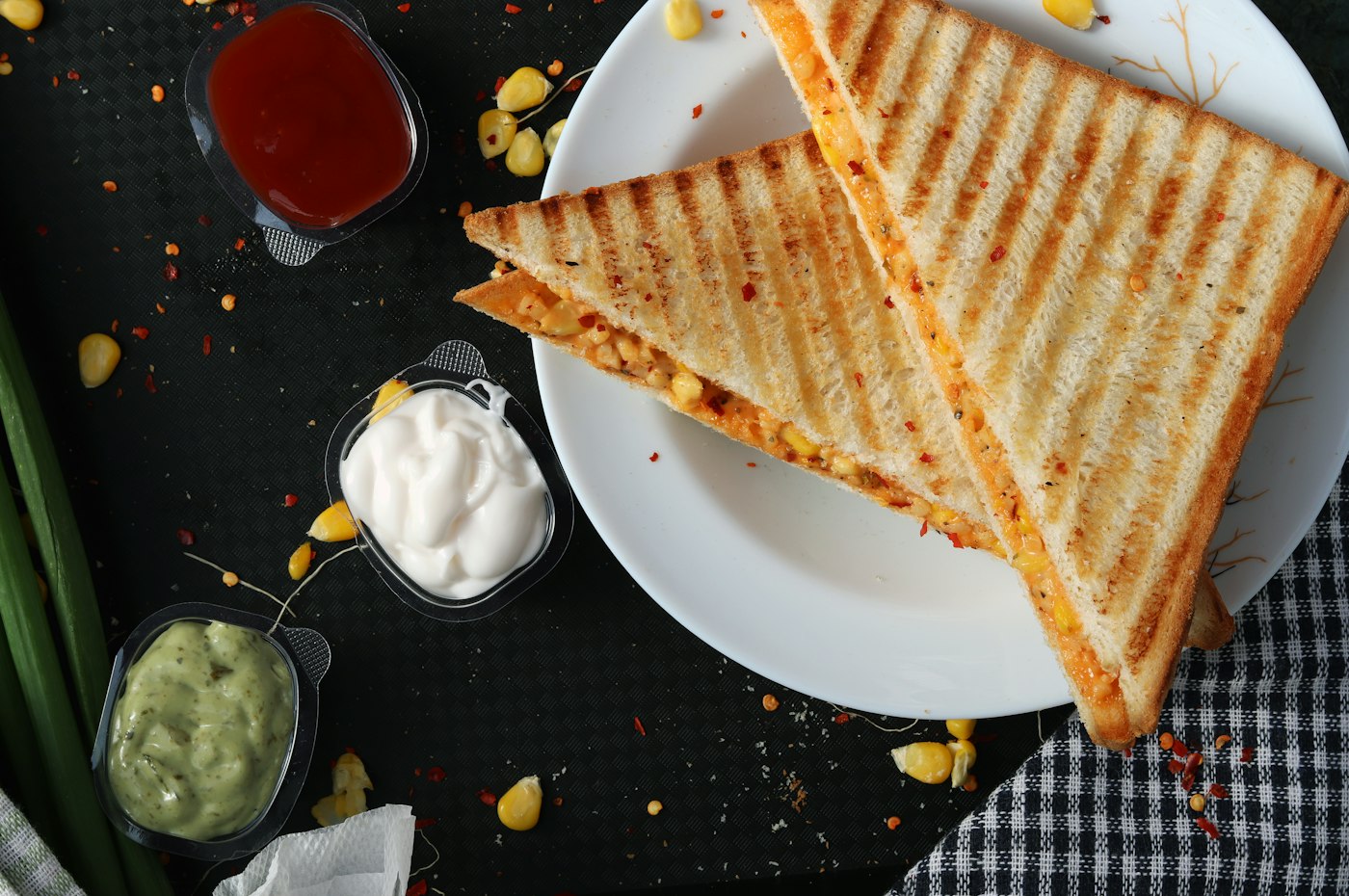 Gourmet sandwich with layered ingredients on a rustic board